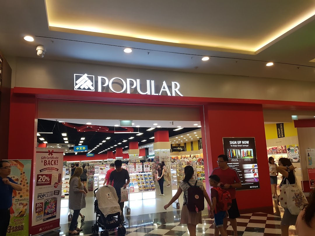 The bustling entrance of a POPULAR Bookstore, with customers entering and promotional banners displayed.