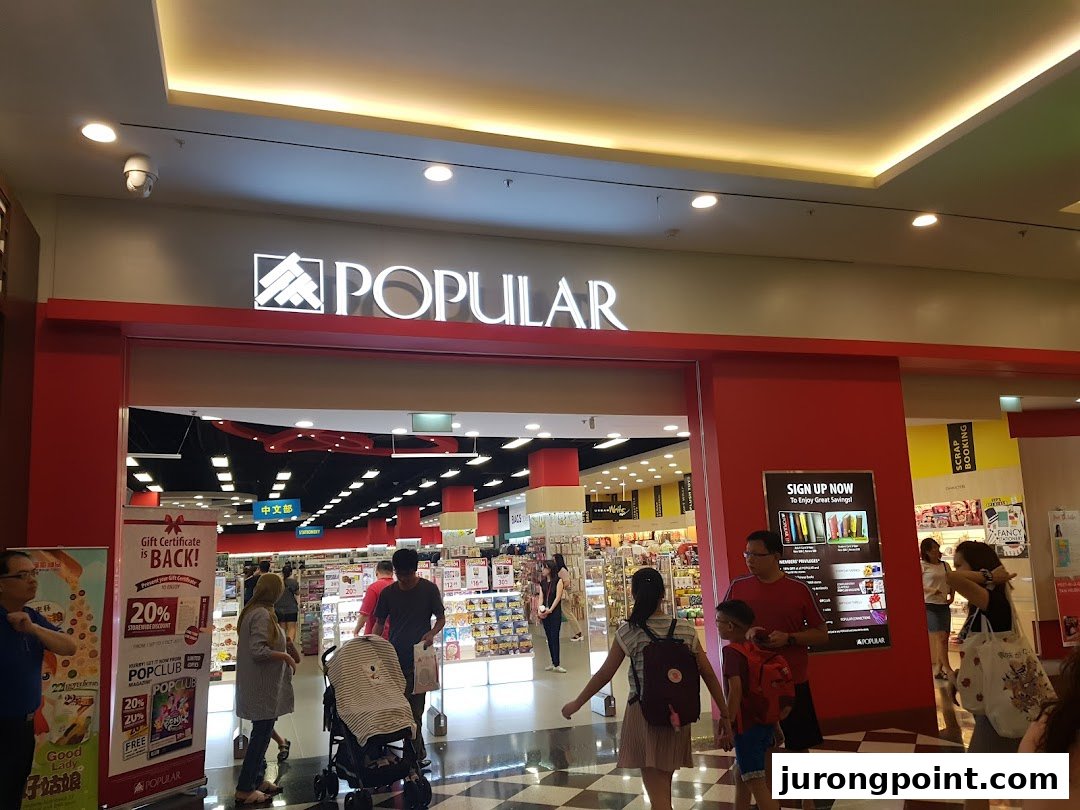 The bustling entrance of a POPULAR Bookstore, with customers entering and promotional banners displayed.