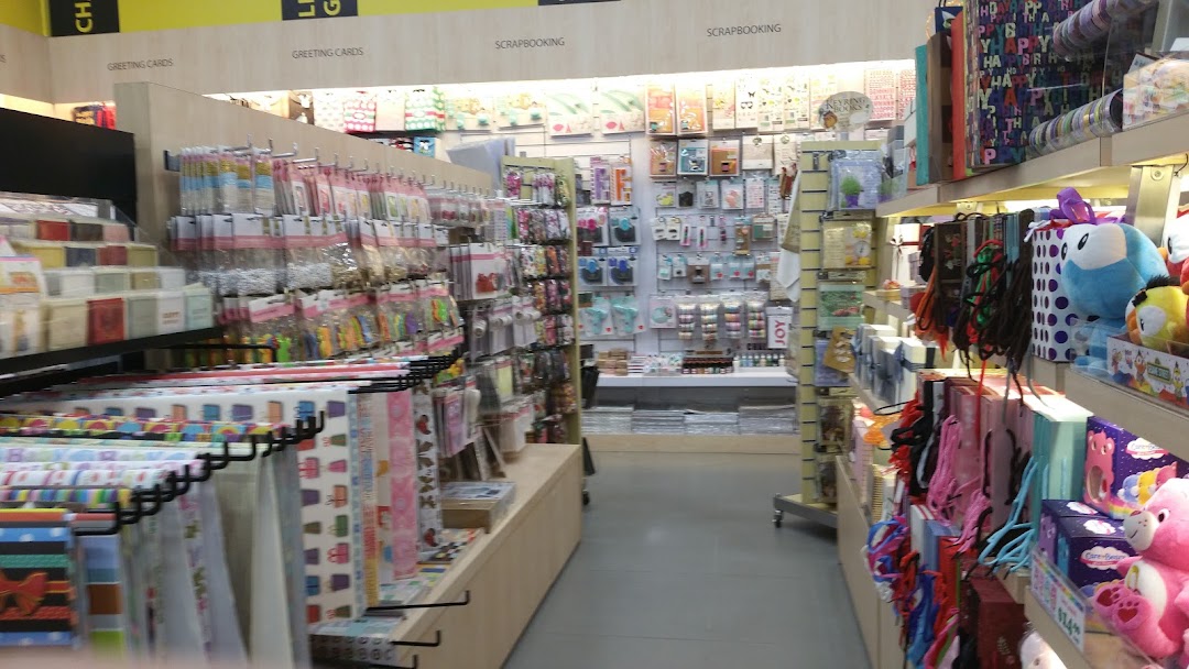 An aisle in Popular Bookstore featuring greeting cards, scrapbooking supplies, and gift items.