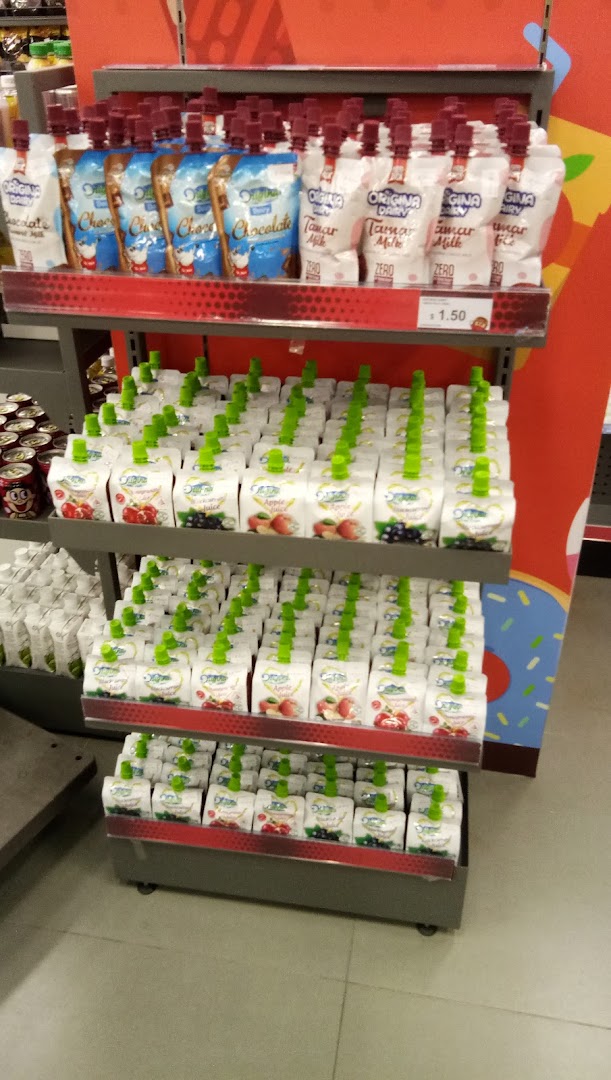 Shelves stocked with various pouch drinks like milk and fruit juices in a retail setting.