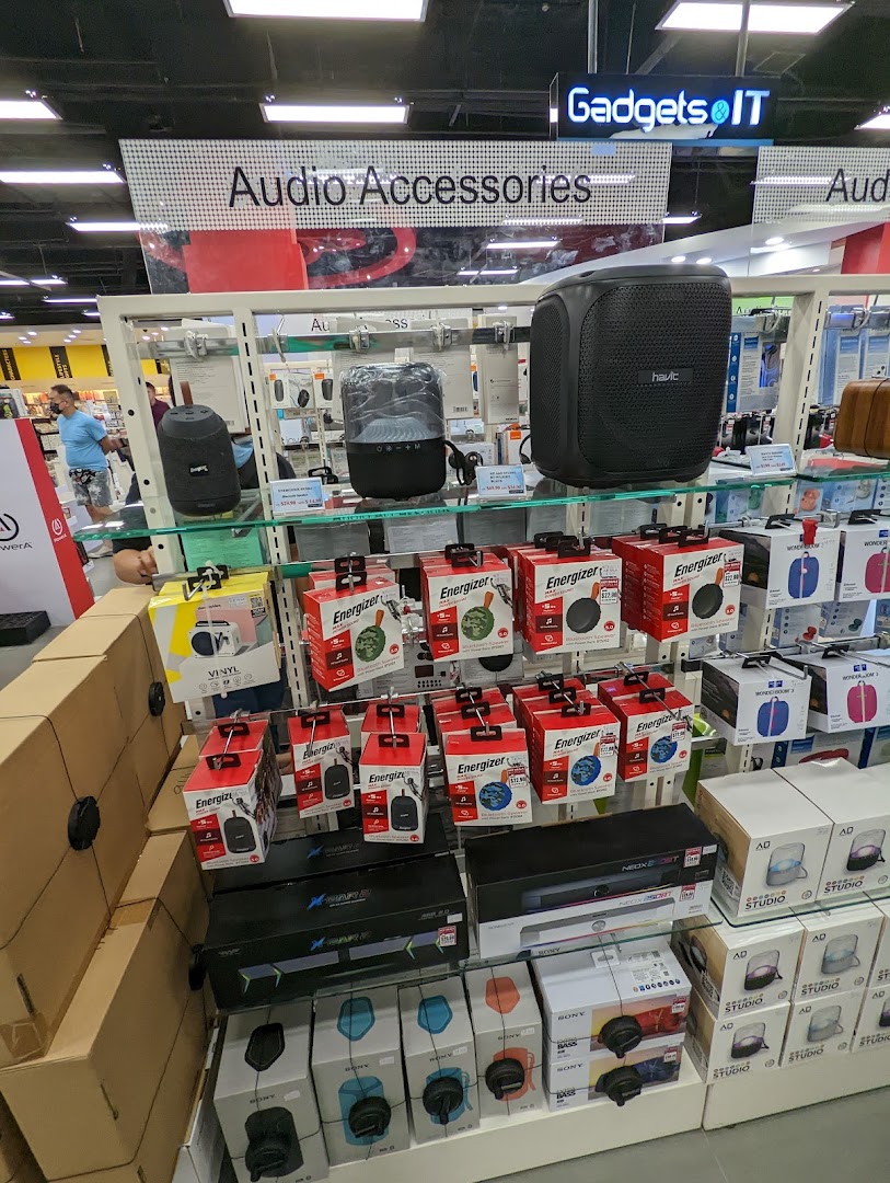 A retail display featuring various audio accessories, speakers, and electronic gadgets.