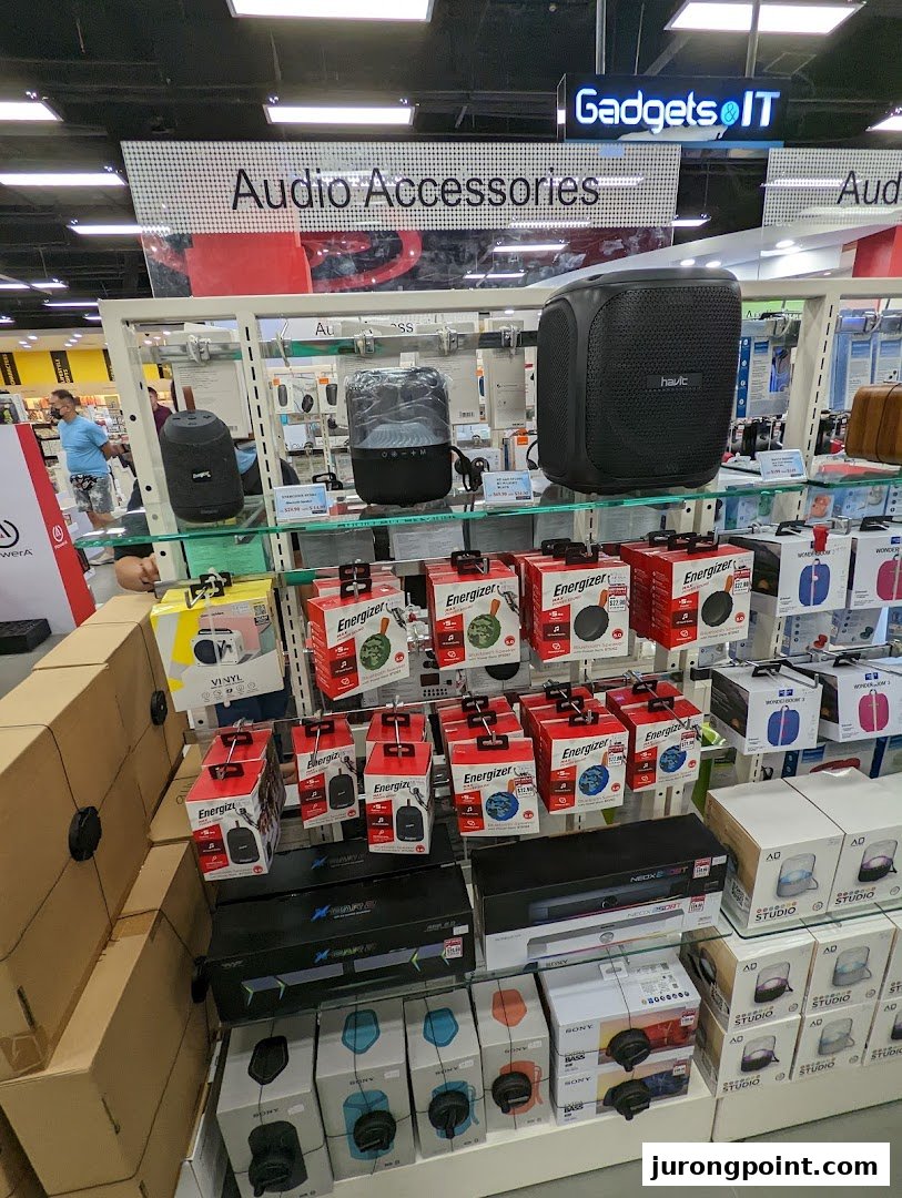 A retail display featuring various audio accessories, speakers, and electronic gadgets.