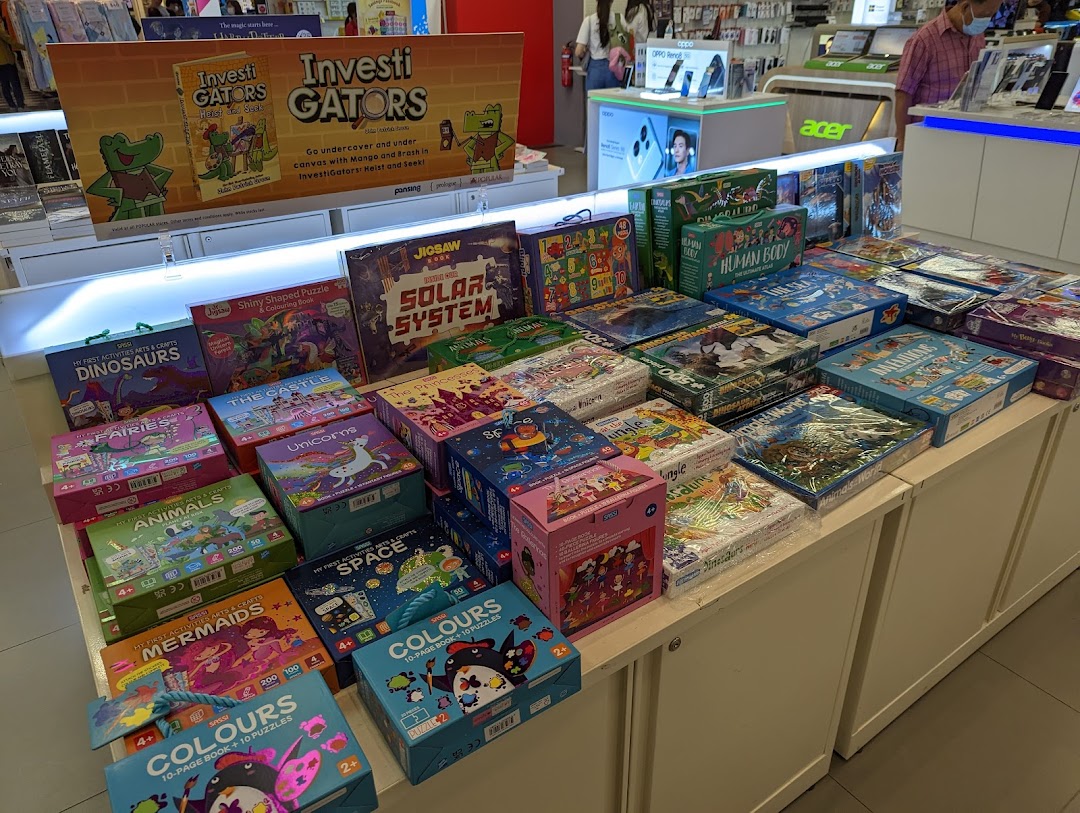 A vibrant display of children's educational books, puzzles, and activity sets at POPULAR Bookstore.