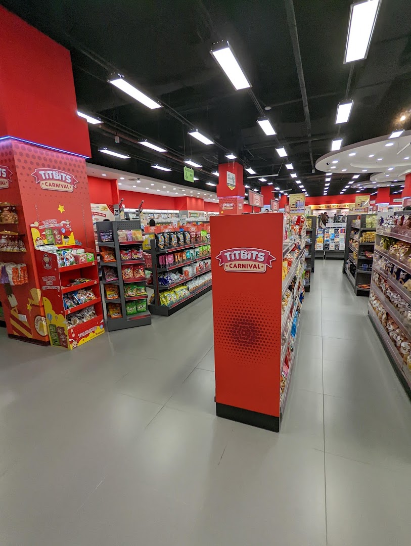 Interior view of a retail store aisle with shelves stocked with various snacks and products.