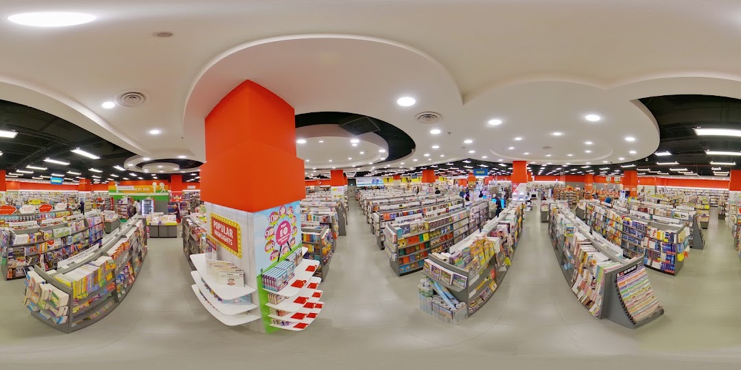 A wide-angle view of the spacious interior of a POPULAR Bookstore, featuring numerous aisles of books and stationery.