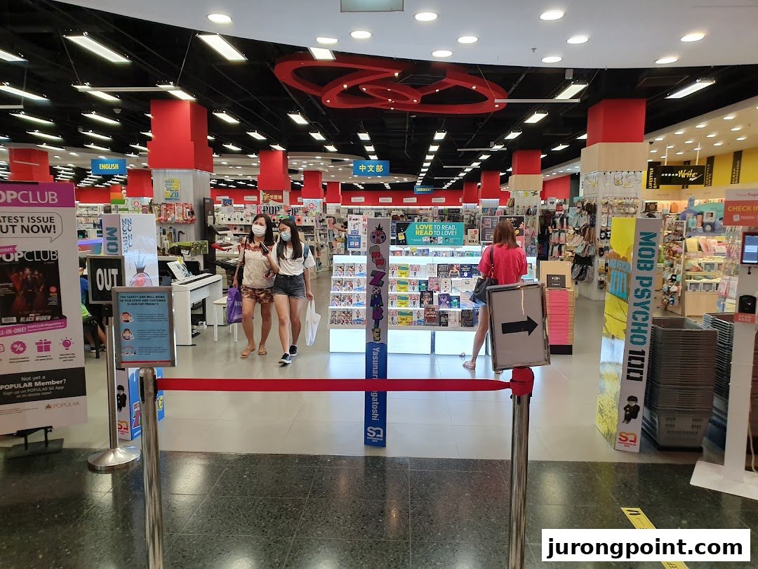 Interior view of POPULAR Bookstore with customers browsing books, stationery, and lifestyle products.