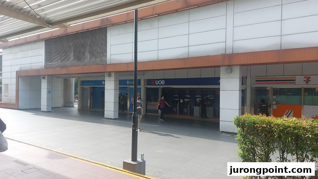 Exterior view of POSB, UOB, and 7-Eleven branches along a mall walkway.