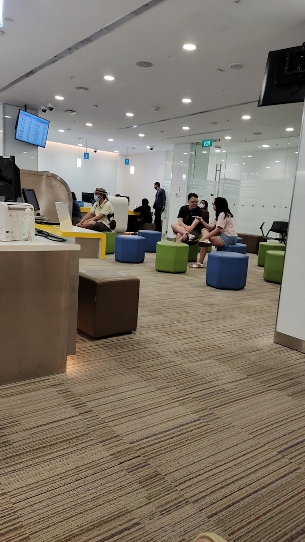 Interior view of POSB Jurong Point Branch, showing customers in a modern waiting area and service counters.