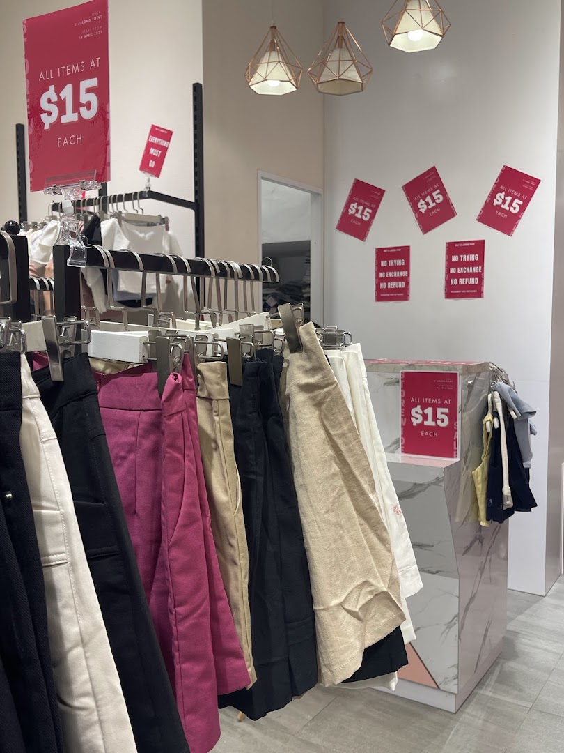 Interior view of Purpur showcasing clothing racks with items on sale for $15 each.