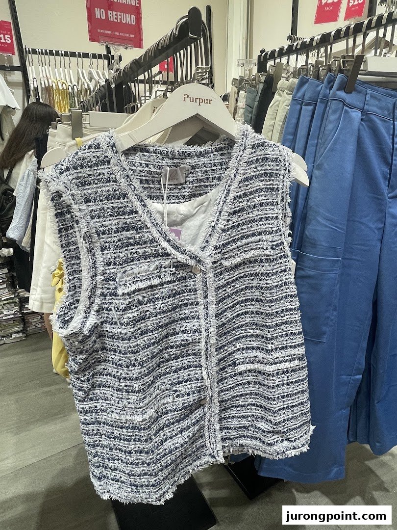 A stylish tweed-like vest on a hanger, showcasing Purpur's fashion collection.