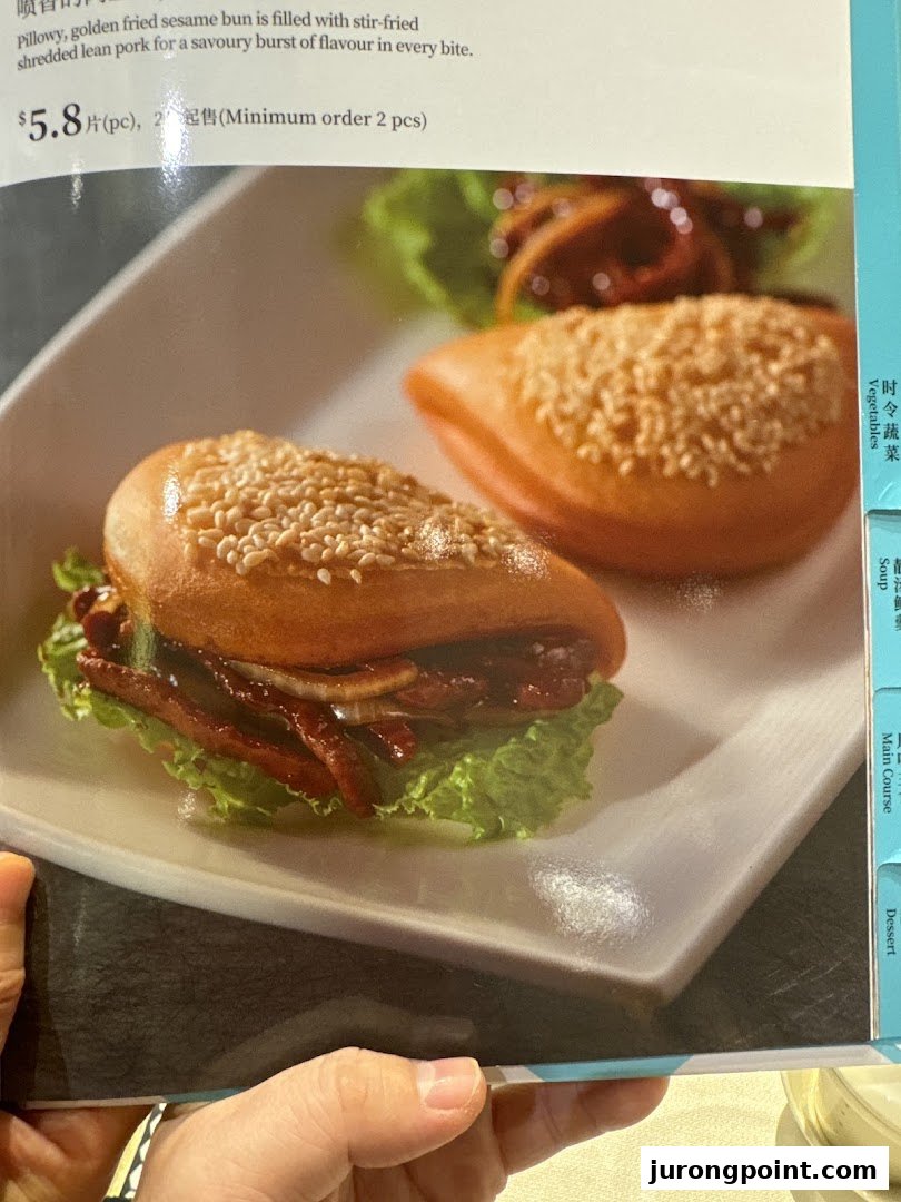 A menu page from PUTIEN showcasing a golden fried sesame bun with shredded lean pork.