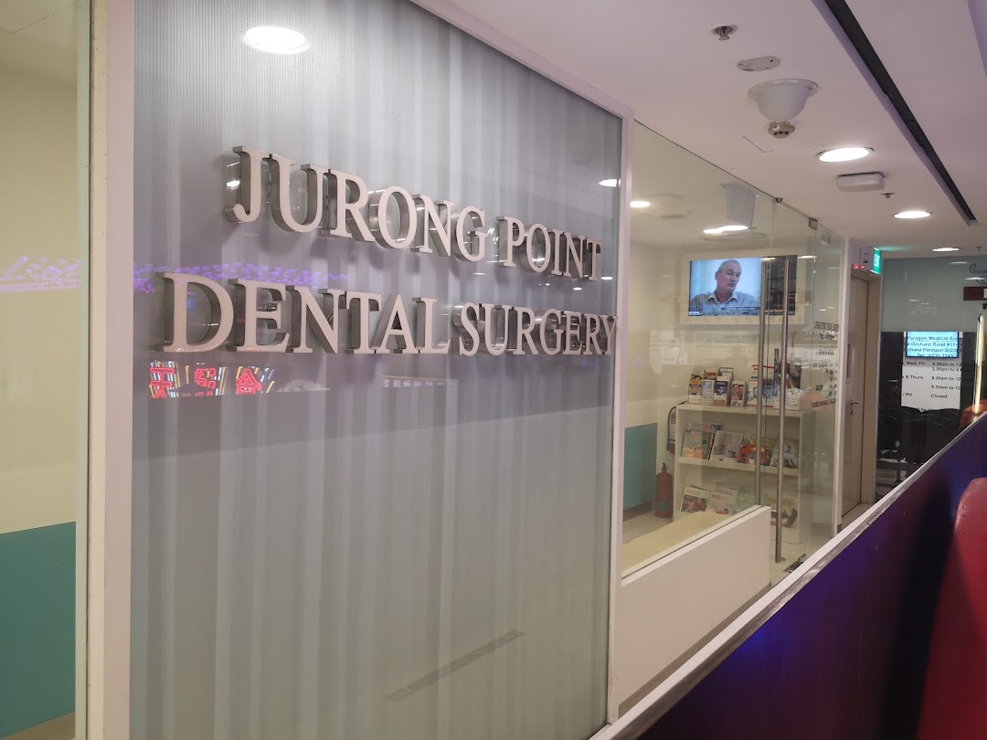 The image shows the glass entrance of Jurong Point Dental Surgery with its prominent signage.
