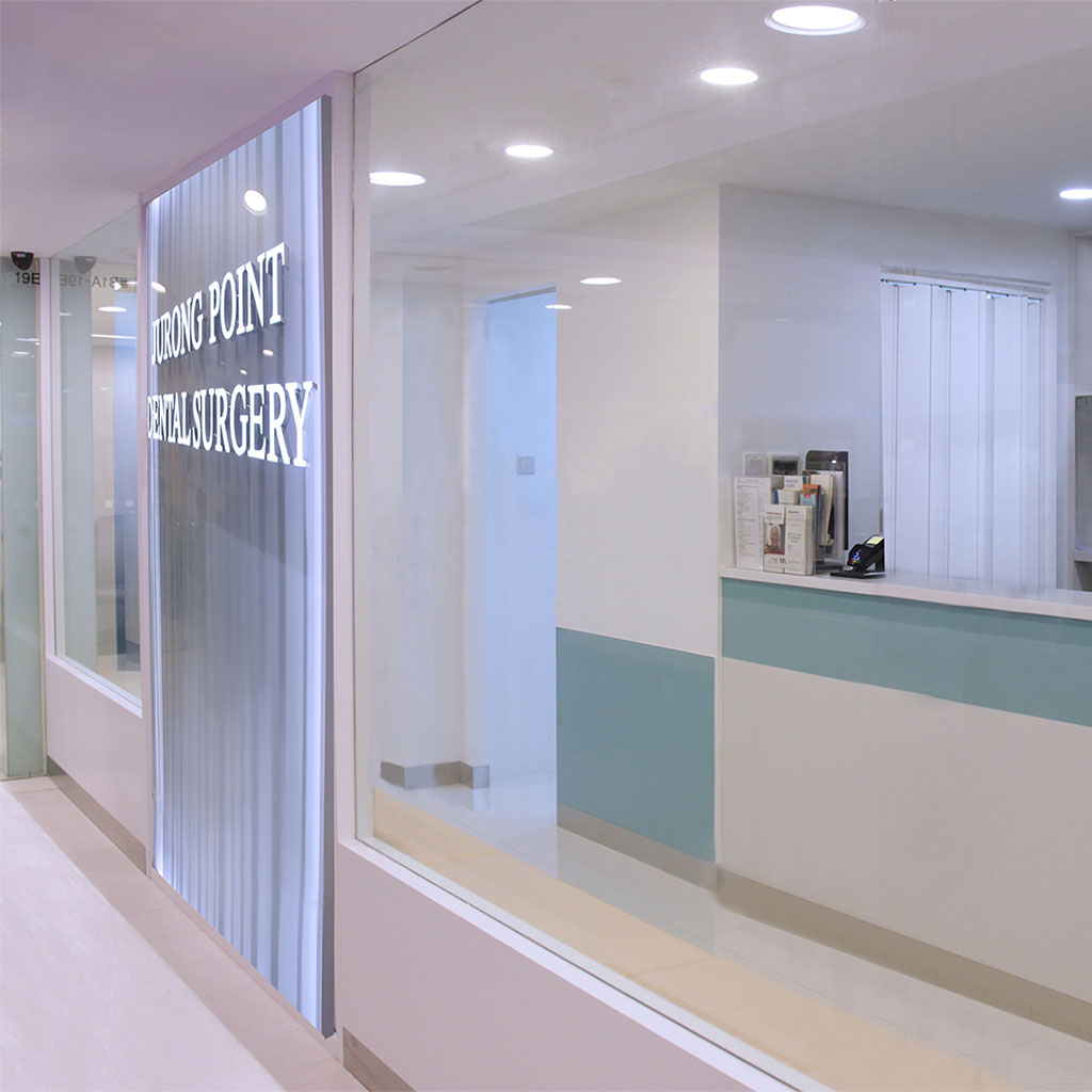 The bright, modern entrance of Jurong Point Dental Surgery, featuring a reception counter and glass facade.