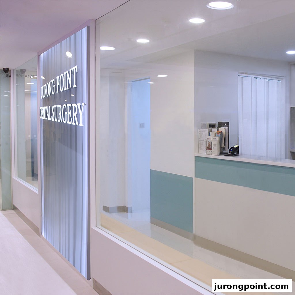 The bright, modern entrance of Jurong Point Dental Surgery, featuring a reception counter and glass facade.