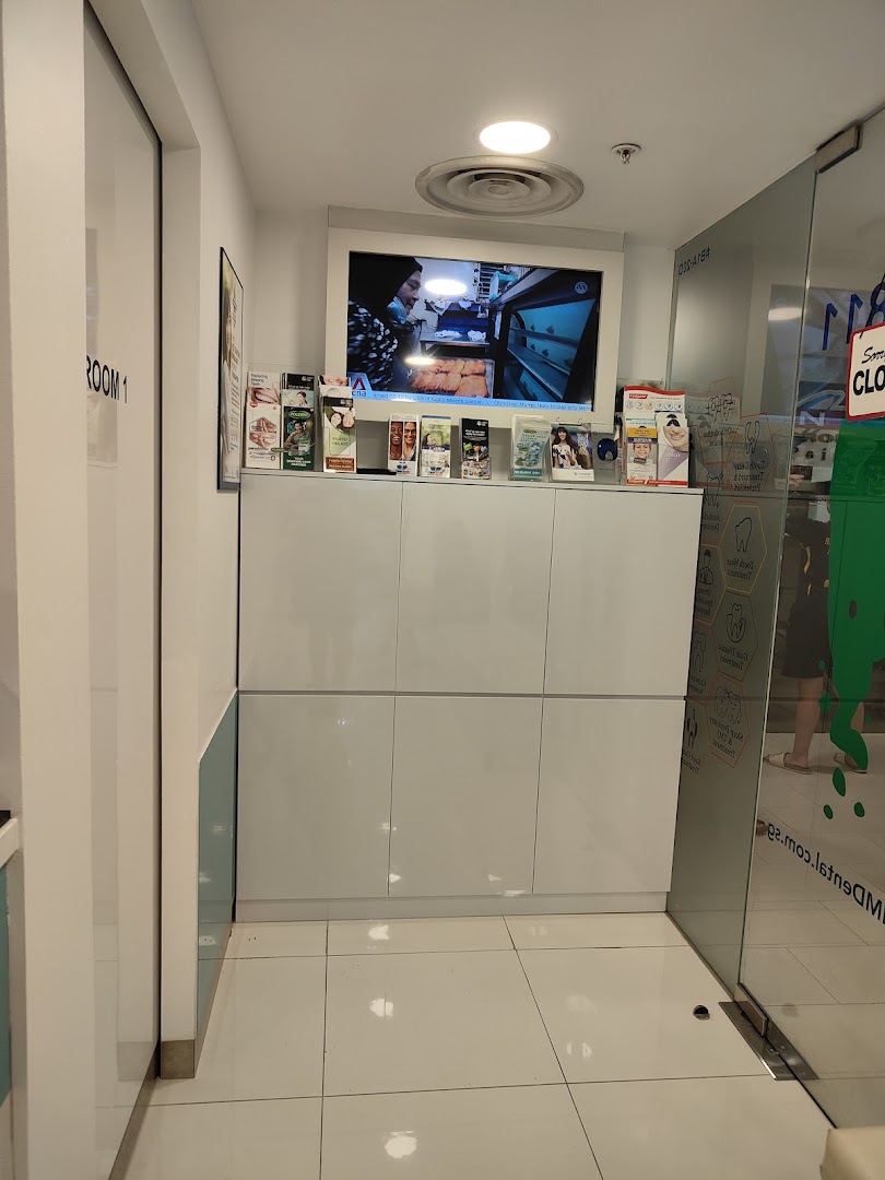 A clean and modern dental clinic interior with a TV and informational brochures.