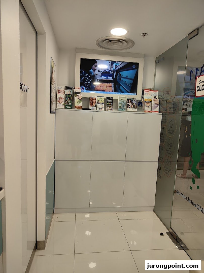 A clean and modern dental clinic interior with a TV and informational brochures.