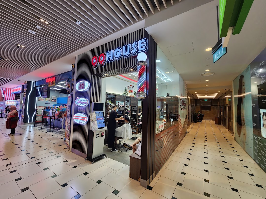 Exterior view of QQ House, a modern barbershop/hair salon, with a barber pole and visible interior activity.