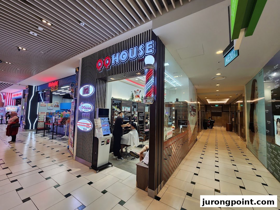 Exterior view of QQ House, a modern barbershop/hair salon, with a barber pole and visible interior activity.