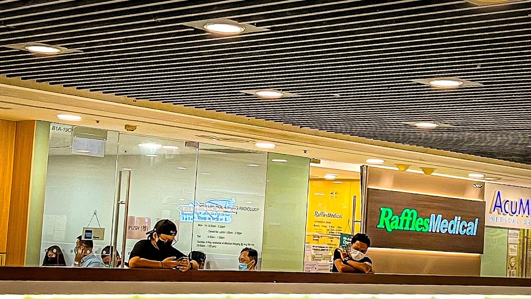 The image shows the shopfronts of RadLink Lite and Raffles Medical clinics within a shopping mall.