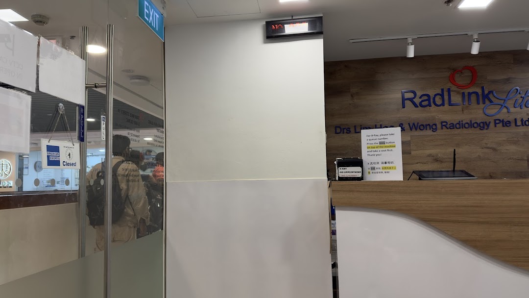 The reception area of RadLink Lite, a radiology clinic, with its service counter and entrance.