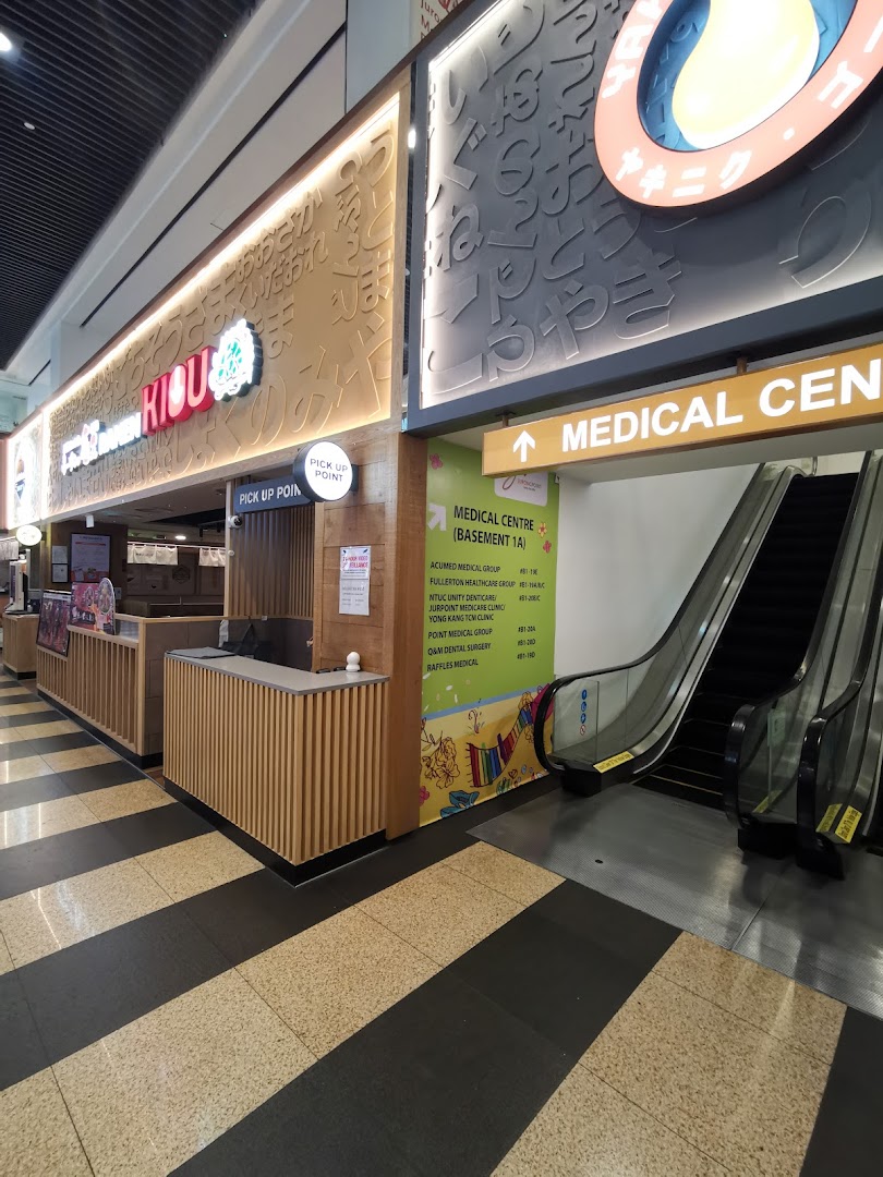 Entrance to Jurong Point's Medical Centre, featuring an escalator and directory of clinics.