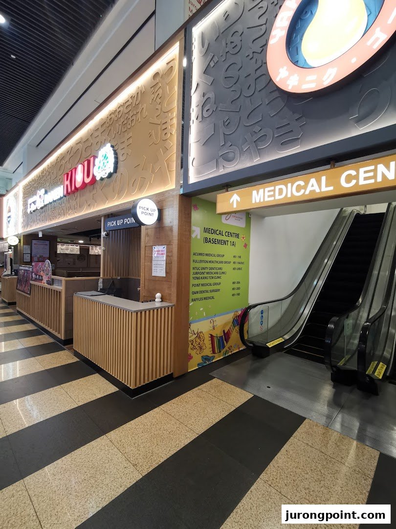 Entrance to Jurong Point's Medical Centre, featuring an escalator and directory of clinics.