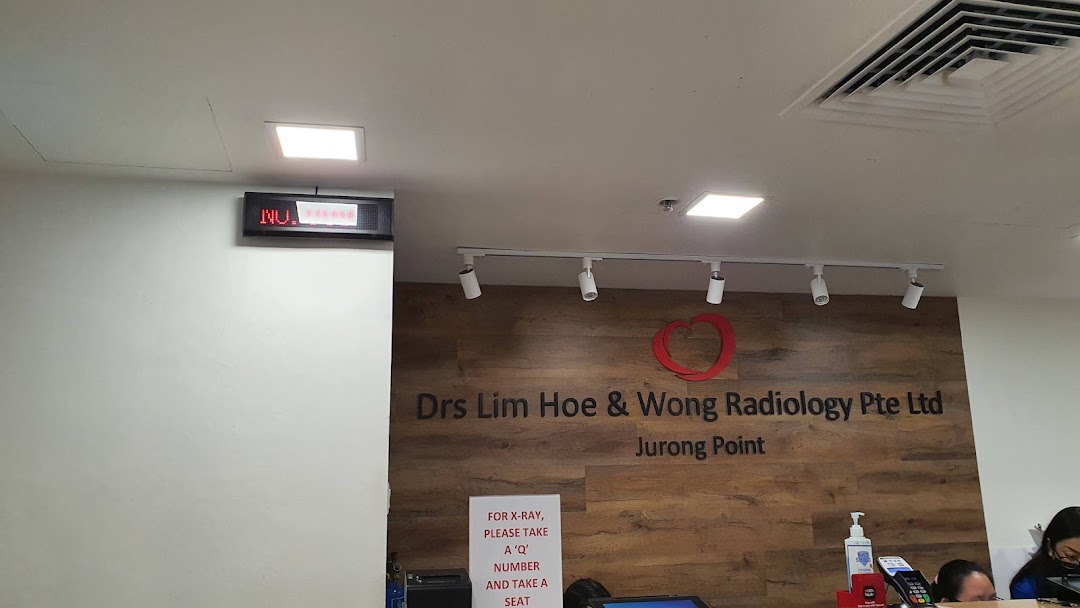 Interior view of Drs Lim Hoe & Wong Radiology reception area with clinic name and queue display.