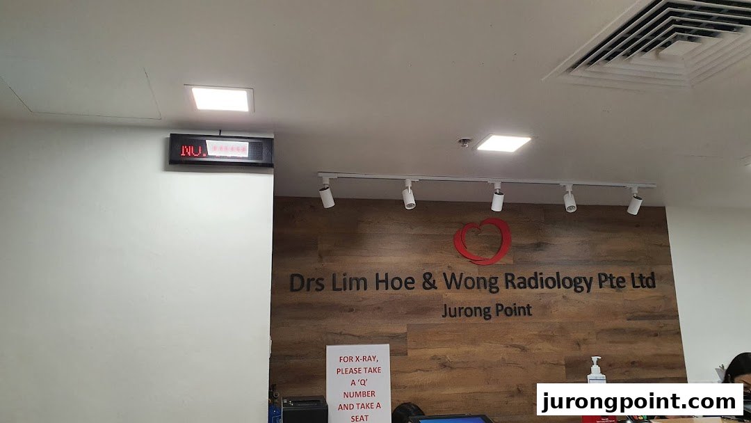 Interior view of Drs Lim Hoe & Wong Radiology reception area with clinic name and queue display.