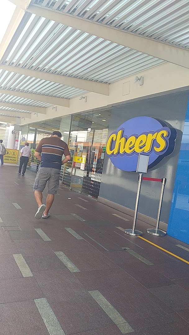 A man walks past the entrance of a Cheers convenience store at Jurong Point.