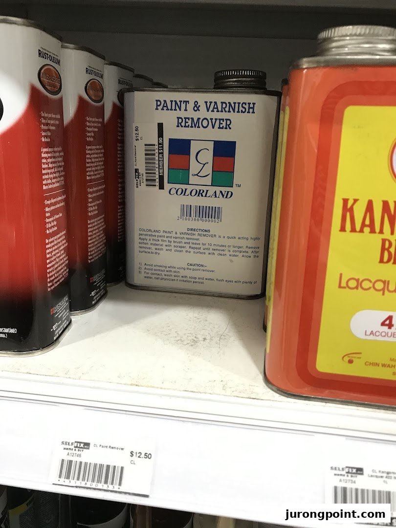 A close-up of paint and varnish remover cans on a shelf at Selffix DIY, with visible price tags.