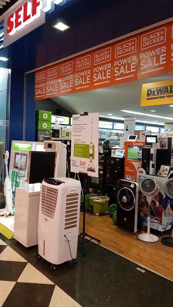 The entrance of Selffix DIY showcasing home appliances, fans, and Black+Decker 'Power Sale' banners.
