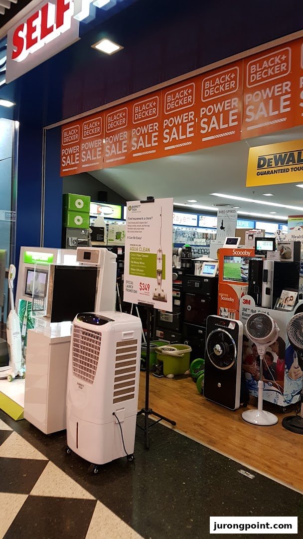 The entrance of Selffix DIY showcasing home appliances, fans, and Black+Decker 'Power Sale' banners.