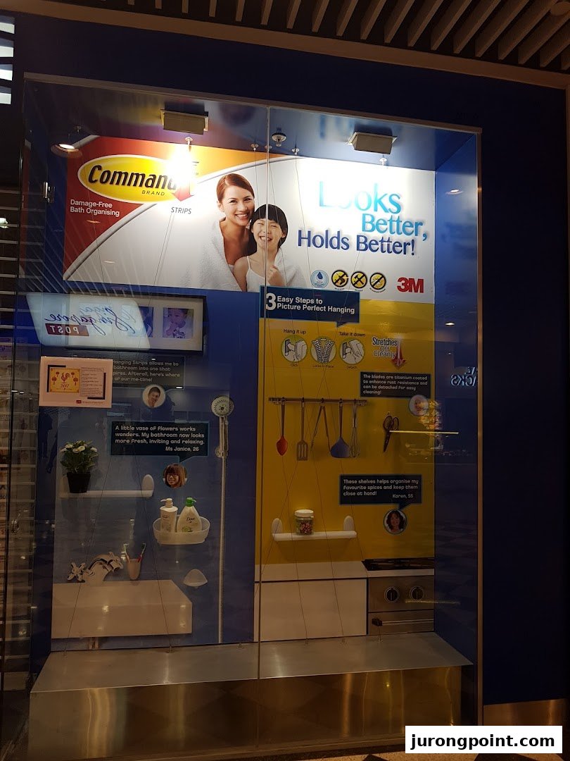 A retail display showcasing Command Brand damage-free hanging solutions for home organization in bathrooms and kitchens.