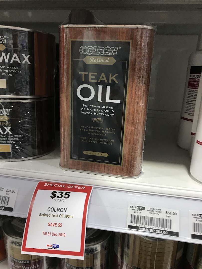 A can of Colron Refined Teak Oil on a retail shelf with a special offer price tag.