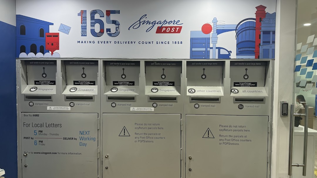 A row of Singapore Post mailboxes and parcel drop-off points for local and international mail.