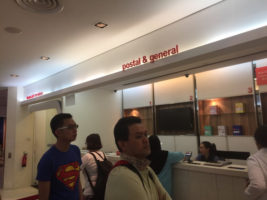 Customers at service counters inside Singapore Post, offering postal, general, and financial services.