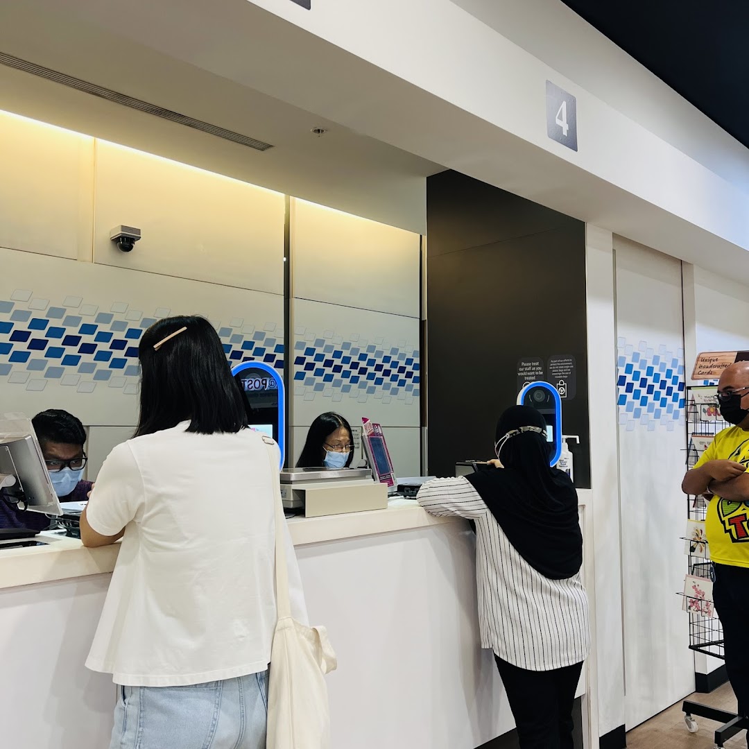 Customers are seen at the service counter of Singapore Post, receiving assistance from staff.