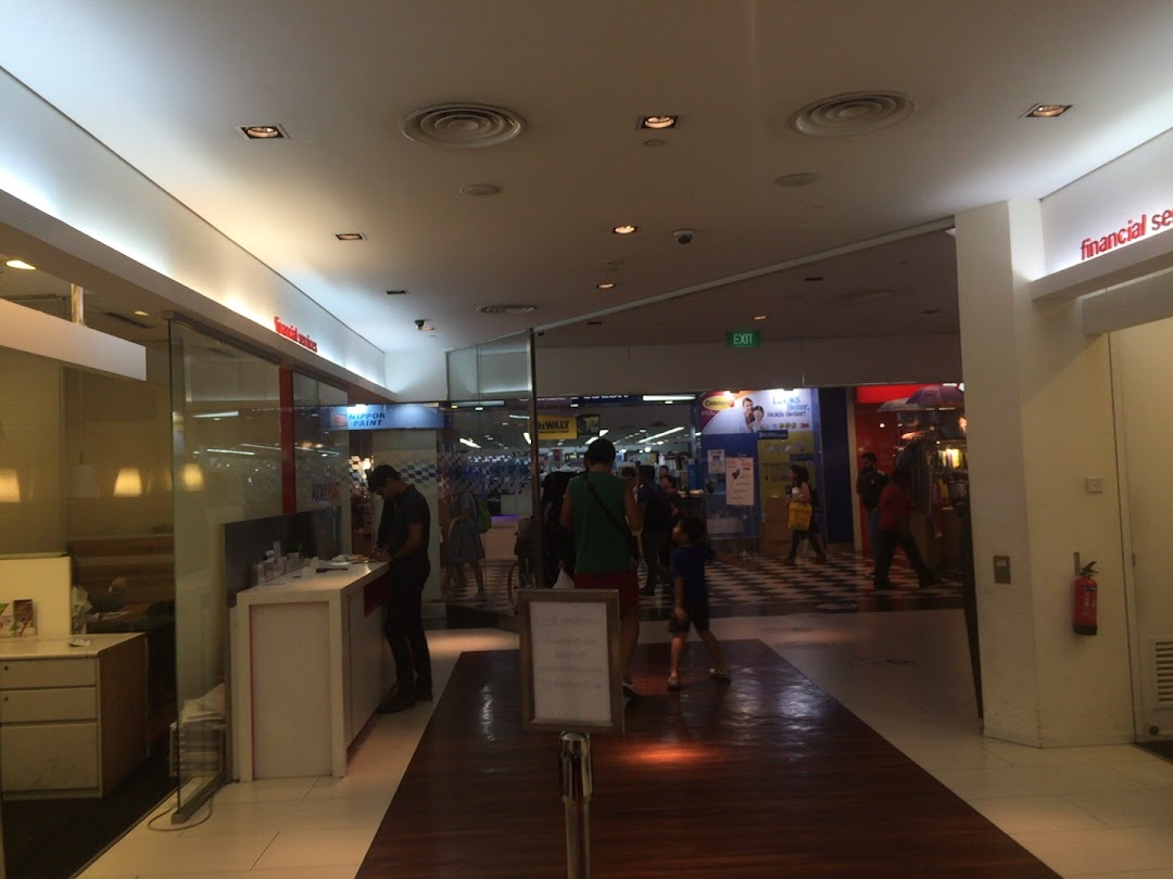 Interior view of a mall corridor showing the Singapore Post branch entrance and shoppers.
