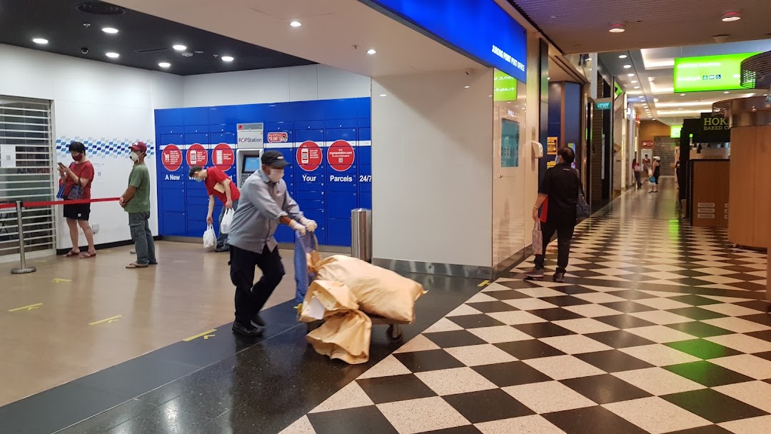 Customers and staff at the Singapore Post parcel locker station within Jurong Point mall.