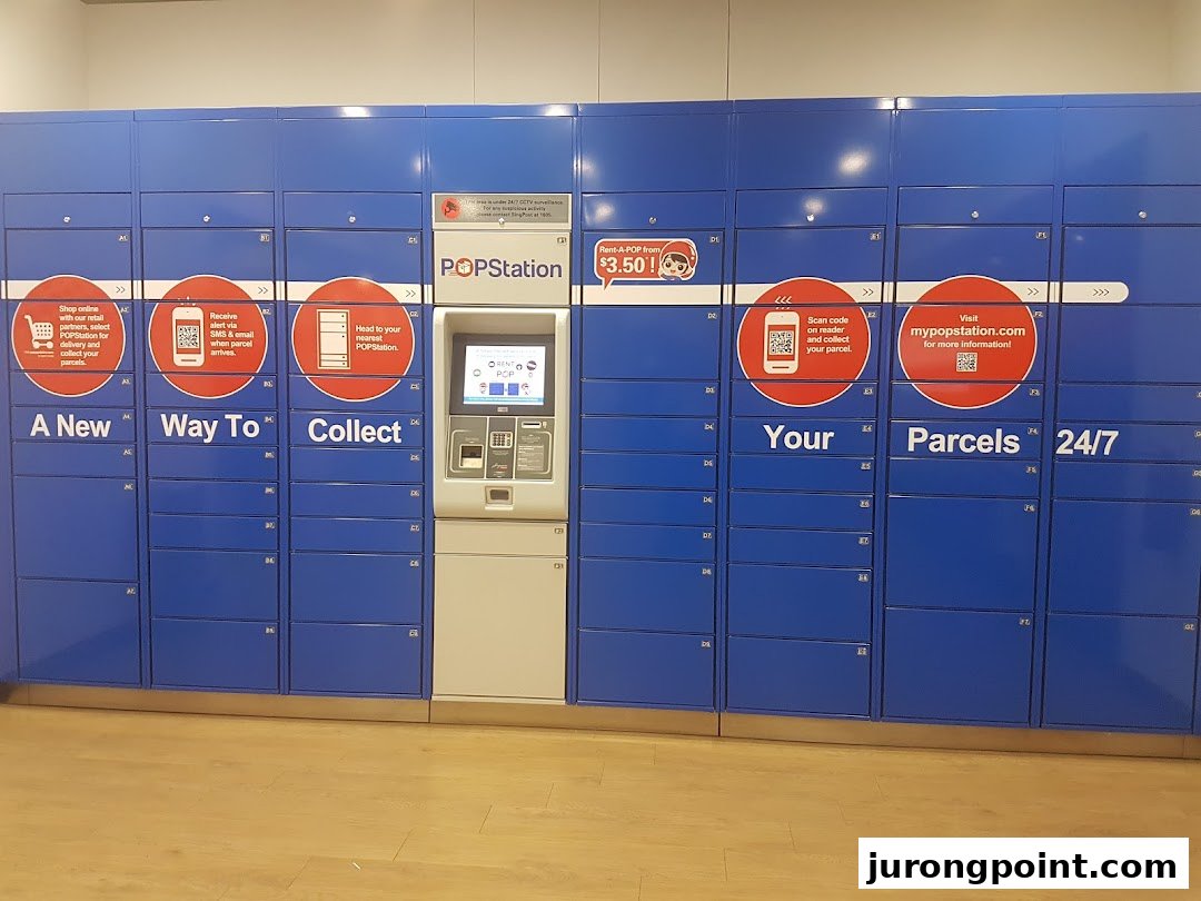 A row of blue POPStation parcel lockers with a central interactive kiosk for 24/7 collection.