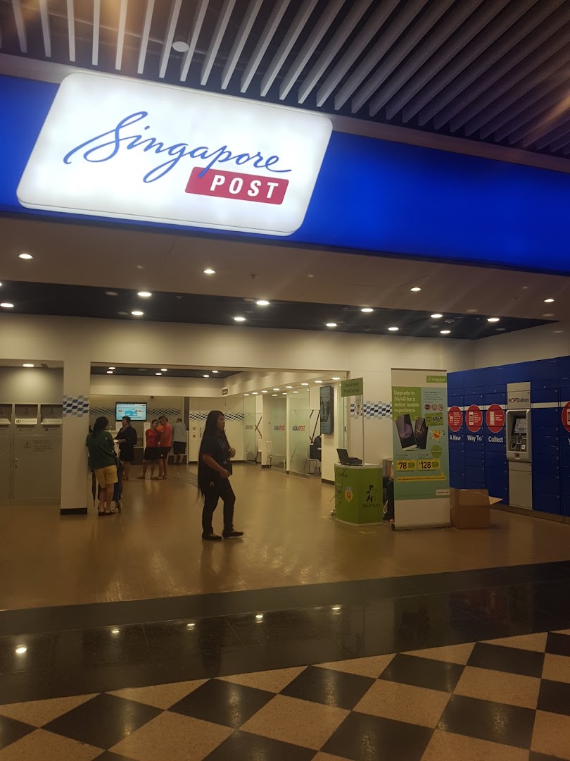 The brightly lit entrance and interior of a Singapore Post branch, showing service areas and customers.