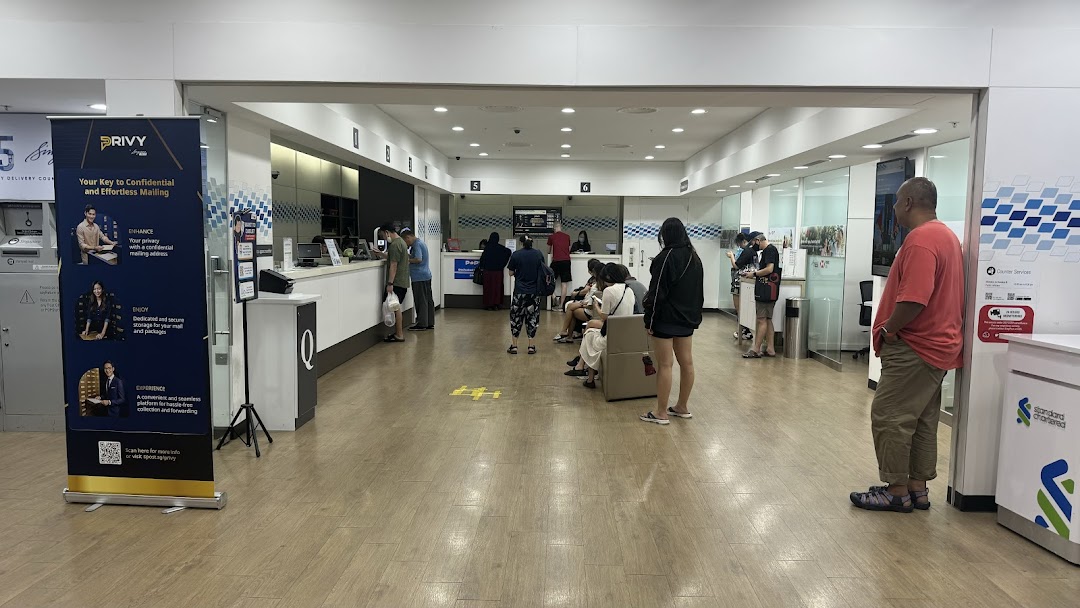Interior view of Singapore Post - Jurong Point Branch with customers at service counters and in the waiting area.