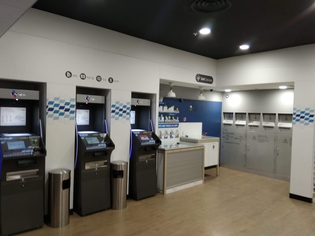 Interior of Singapore Post's self-service area featuring kiosks and parcel lockers.