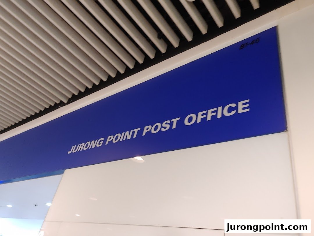 A blue sign for Jurong Point Post Office, indicating its location within the mall.