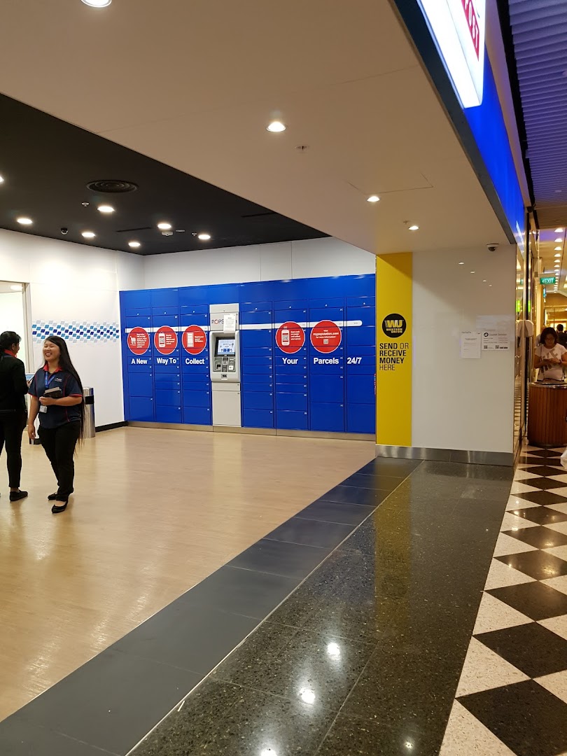 Interior view of Singapore Post's POPStation lockers for 24/7 parcel collection and sending, with a staff member present.