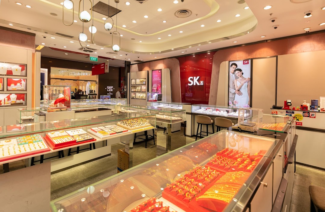 An interior view of SK Gold jewelry store, showcasing numerous display cases filled with gold and precious jewelry.