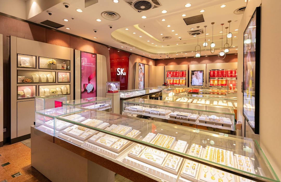 An interior view of SK Gold jewelry store, showcasing numerous display cases filled with gold and silver jewelry.