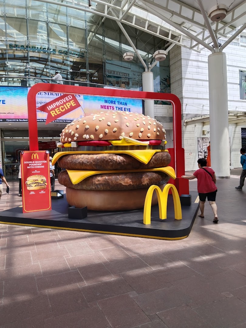 A large McDonald's promotional display featuring a giant Double Quarter Pounder with Cheese.