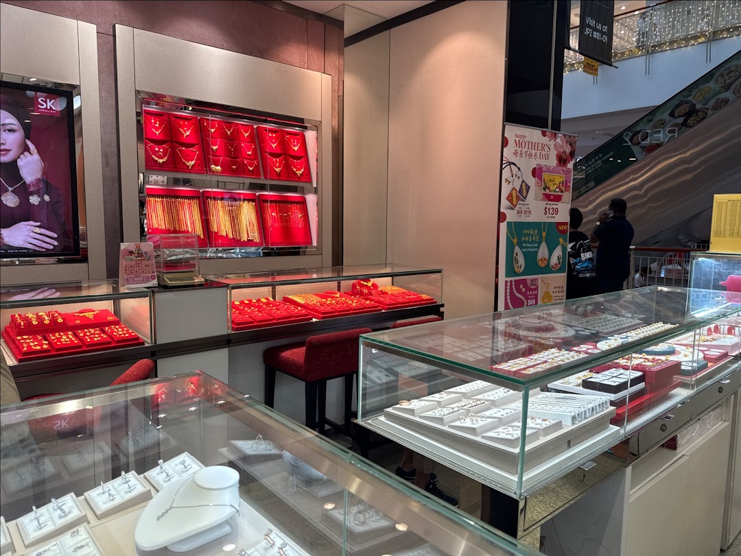 Interior view of SK Gold jewelry store showcasing a wide array of gold and silver pieces in display cases.