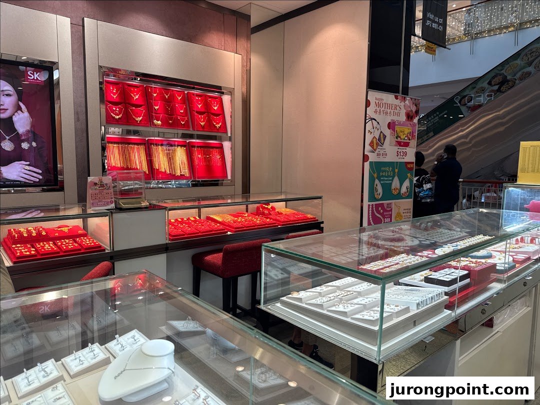 Interior view of SK Gold jewelry store showcasing a wide array of gold and silver pieces in display cases.